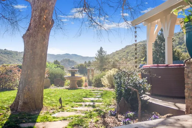 a view of a house with a yard and sitting area