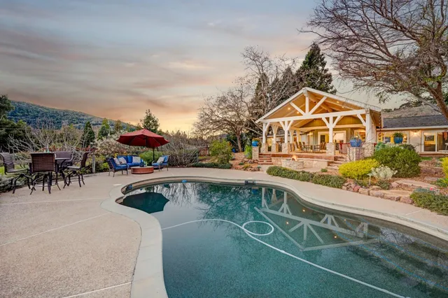 an aerial view of a house with a yard basket ball court and outdoor seating