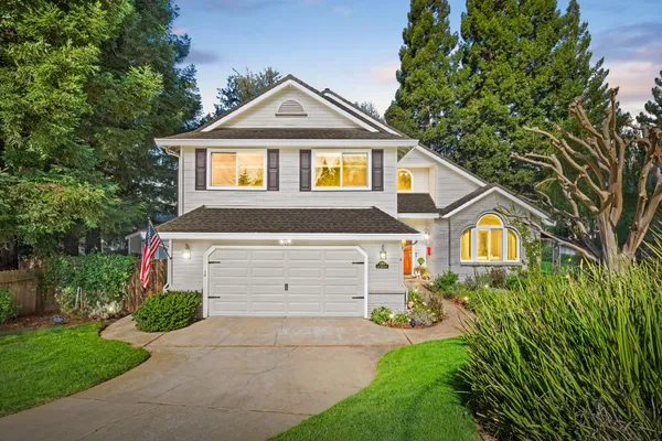 a front view of a house with a yard and garage