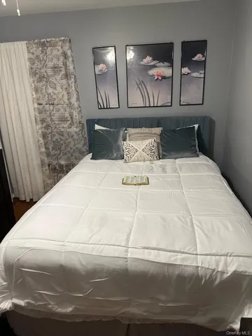 a large white bed in a small room