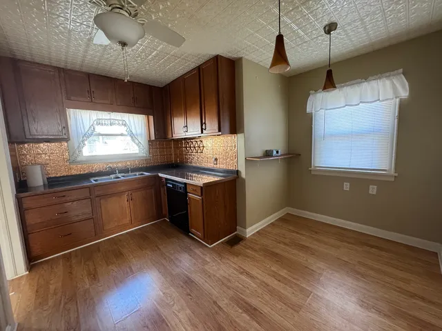 a kitchen with granite countertop stainless steel appliances and wooden cabinets