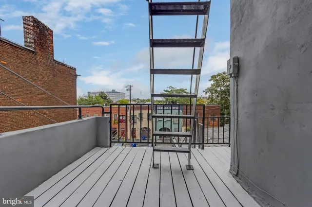 a view of balcony with wooden floor and city view