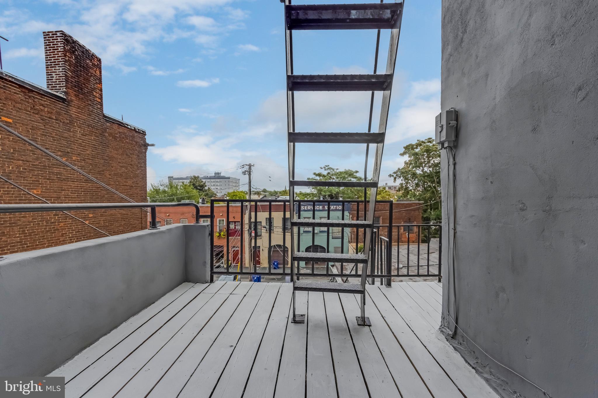1113 North Calvert Street, Unit B Baltimore, MD 21202 - Photo 4 of 6 a view of balcony with wooden floor and city view