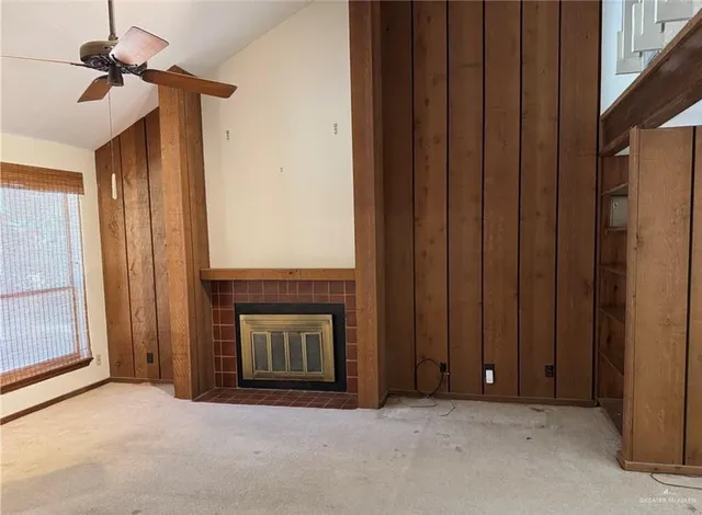 a view of an empty room with a fireplace