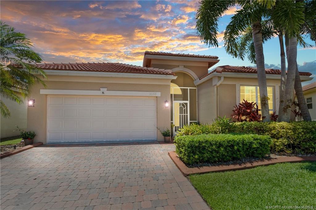 2688 Southeast Castle Pine Place Stuart, FL 34997 - Photo 1 of 49 a front view of house with yard and green space