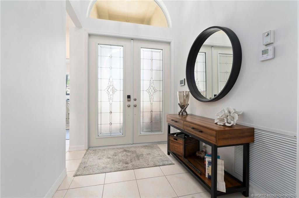 2688 Southeast Castle Pine Place Stuart, FL 34997 - Photo 11 of 49 a bathroom with a sink a toilet and a mirror