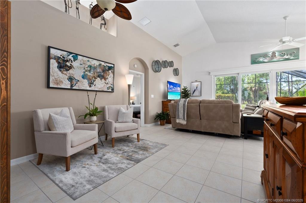 2688 Southeast Castle Pine Place Stuart, FL 34997 - Photo 12 of 49 a living room with furniture and a large window