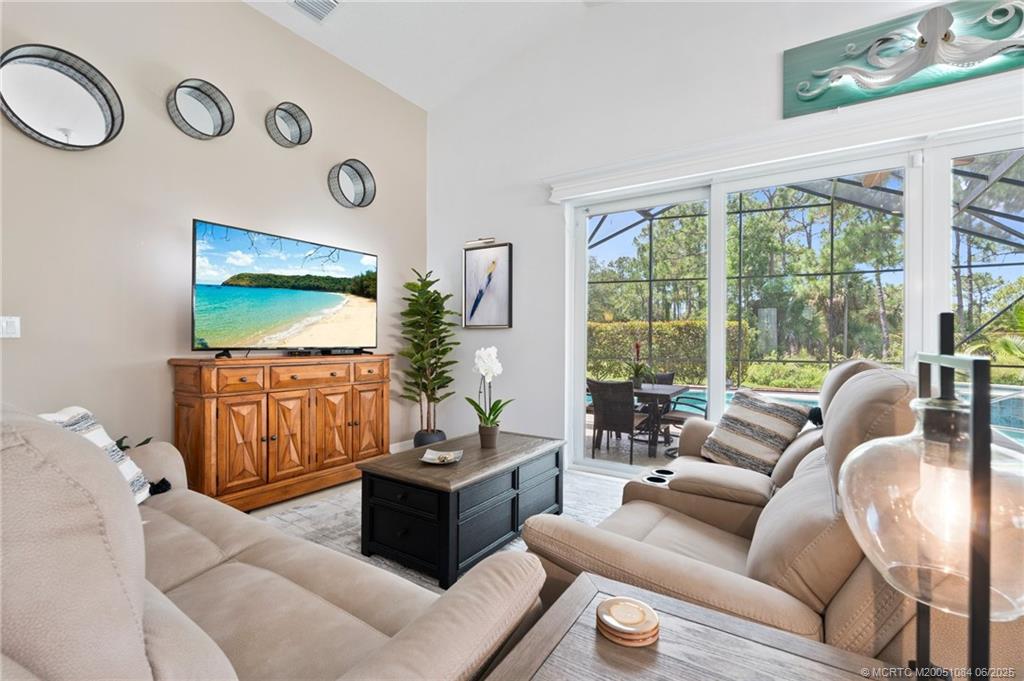 2688 Southeast Castle Pine Place Stuart, FL 34997 - Photo 14 of 49 a living room with furniture and a flat screen tv