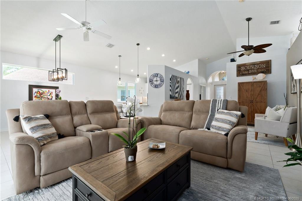 2688 Southeast Castle Pine Place Stuart, FL 34997 - Photo 16 of 49 a living room with furniture and a chandelier