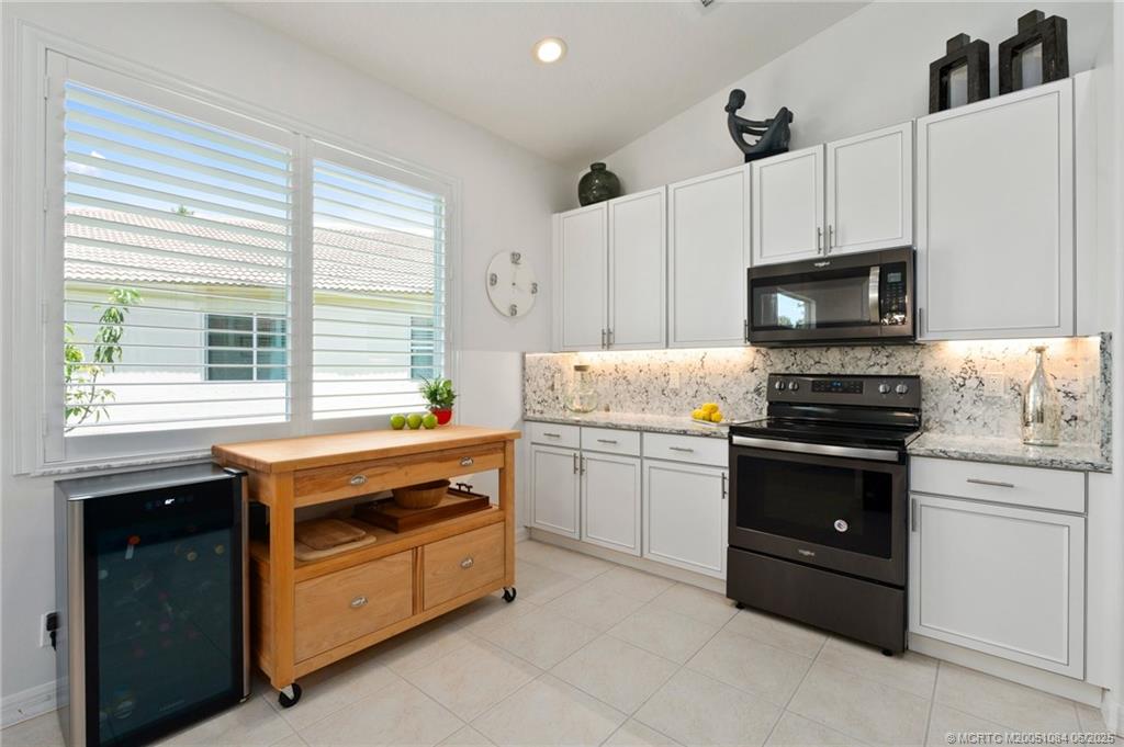 2688 Southeast Castle Pine Place Stuart, FL 34997 - Photo 21 of 49 a kitchen with a stove and a microwave