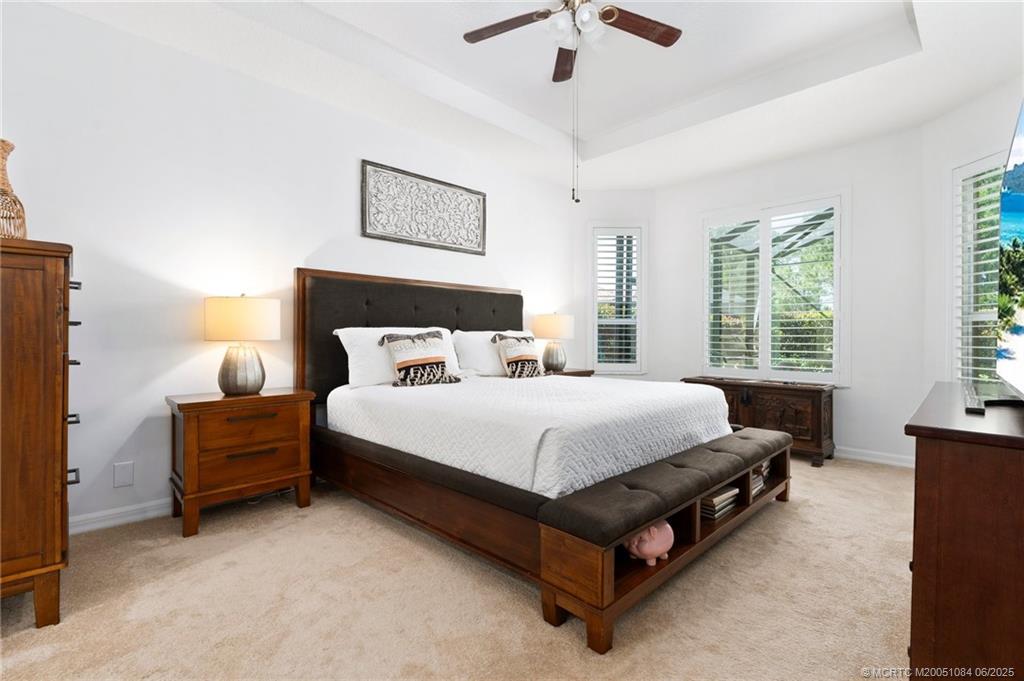 2688 Southeast Castle Pine Place Stuart, FL 34997 - Photo 25 of 49 a bed sitting in a spacious bedroom next to a window