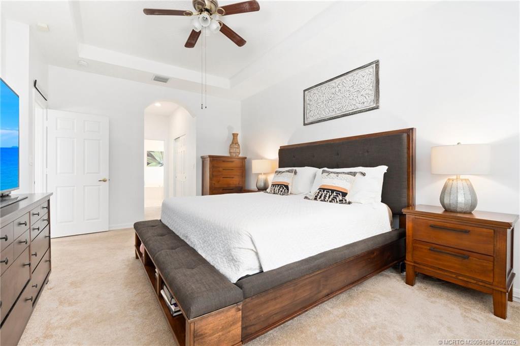 2688 Southeast Castle Pine Place Stuart, FL 34997 - Photo 26 of 49 a bedroom with a bed and window
