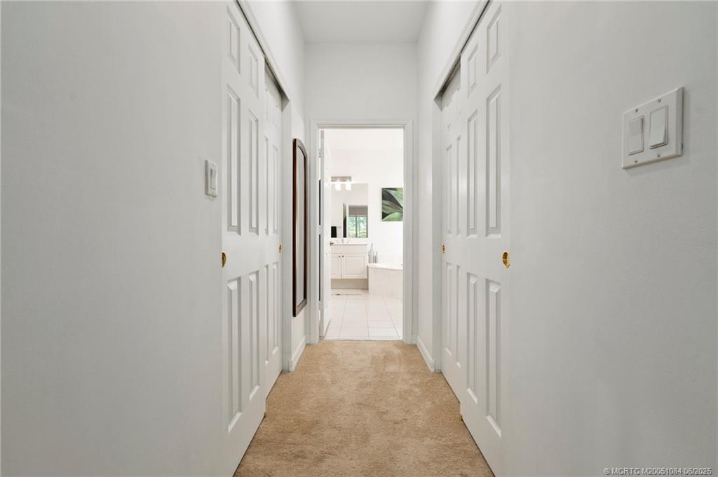2688 Southeast Castle Pine Place Stuart, FL 34997 - Photo 27 of 49 a view of a hallway with white walls and stairs