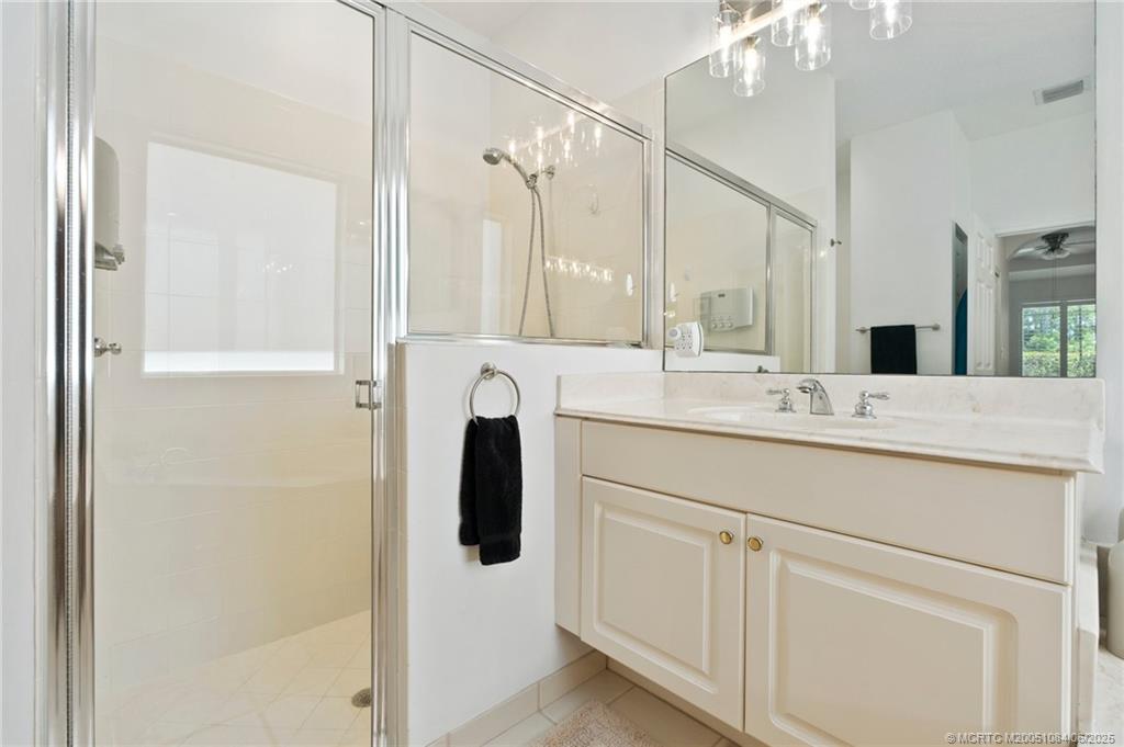 2688 Southeast Castle Pine Place Stuart, FL 34997 - Photo 30 of 49 a bathroom with a sink and a mirror