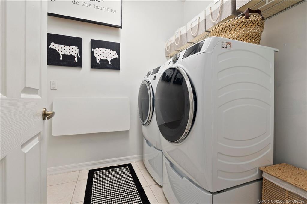 2688 Southeast Castle Pine Place Stuart, FL 34997 - Photo 31 of 49 a utility room with dryer and washer