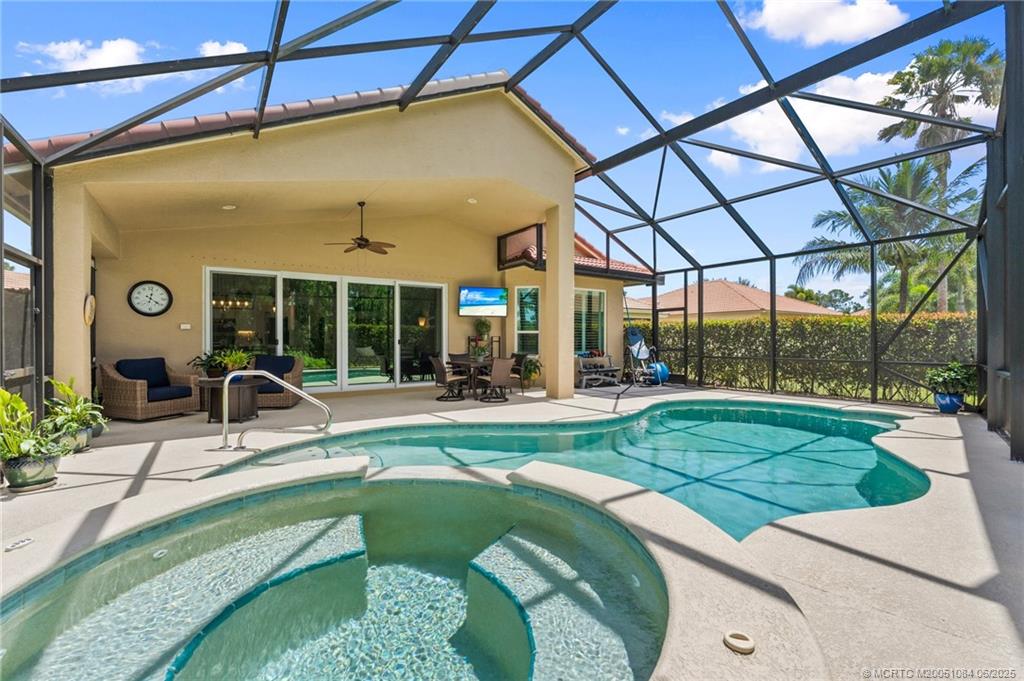 2688 Southeast Castle Pine Place Stuart, FL 34997 - Photo 34 of 49 a view of a patio with a table and chairs under an umbrella