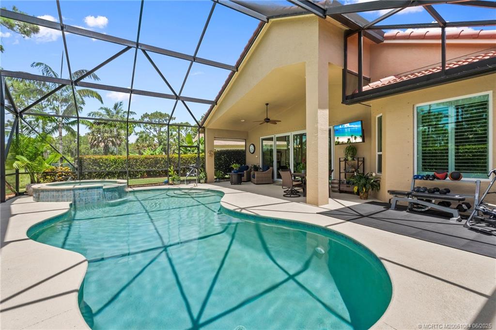 2688 Southeast Castle Pine Place Stuart, FL 34997 - Photo 35 of 49 a view of a swimming pool with a patio