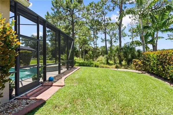 a view of a house with backyard and sitting area