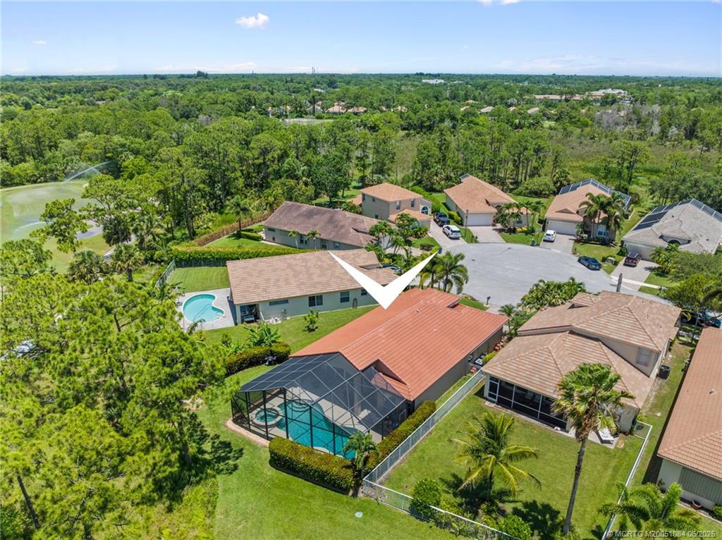 2688 Southeast Castle Pine Place Stuart, FL 34997 - Photo 41 of 49 an aerial view of a house with a garden and lake view