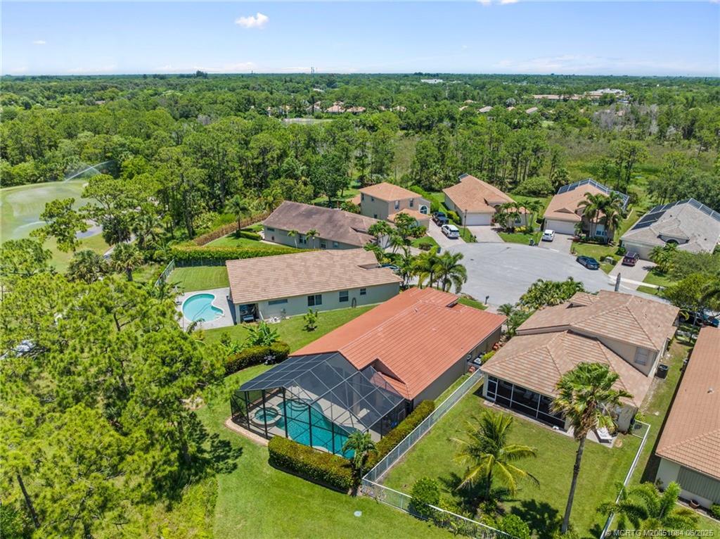 2688 Southeast Castle Pine Place Stuart, FL 34997 - Photo 42 of 49 an aerial view of a house with a garden and lake view