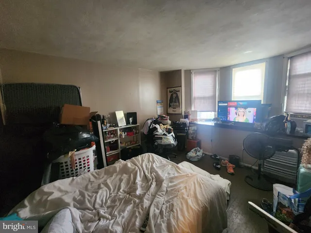 a bedroom with a bed and dresser