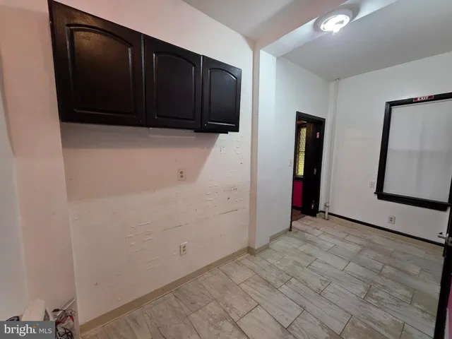 a view of a big room with wooden floors and a ceiling fan