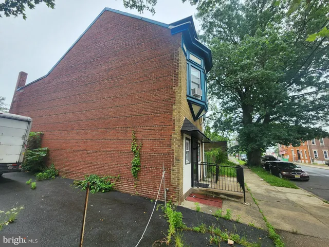 a brick building with a bench in front of it
