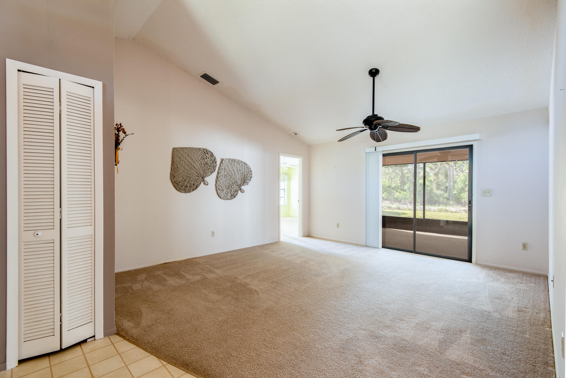 248 Rheine Road Northwest Palm Bay, FL 32907 - Photo 5 of 22 a view of a livingroom with a chandelier fan and windows