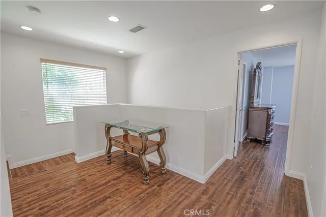 a view of a chair and table under an umbrella in patio