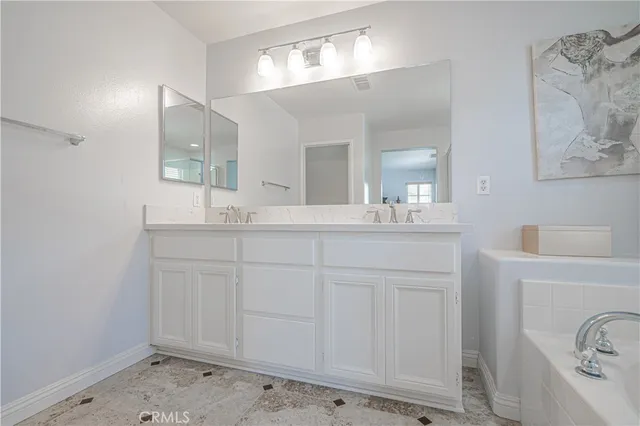 a white bath tub sitting next to a shower