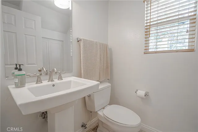 a dining room with furniture a chandelier and wooden floor