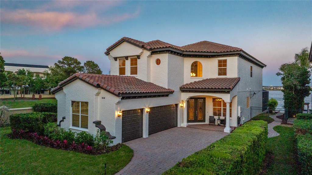 8119 Vía Rosa Orlando, FL 32836 - Photo 59 of 62 a front view of a house with a yard and garage