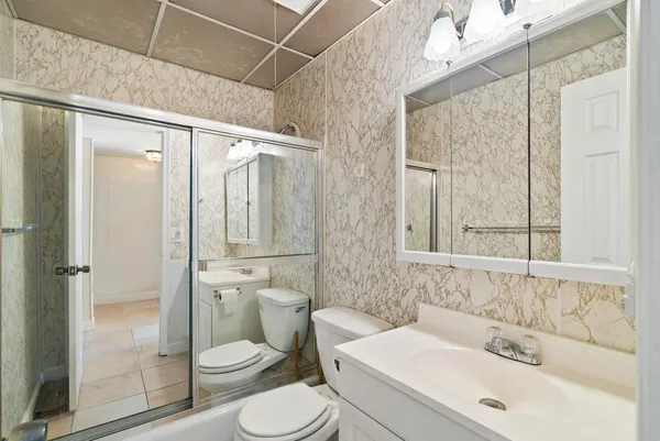 a bathroom with a sink toilet and shower