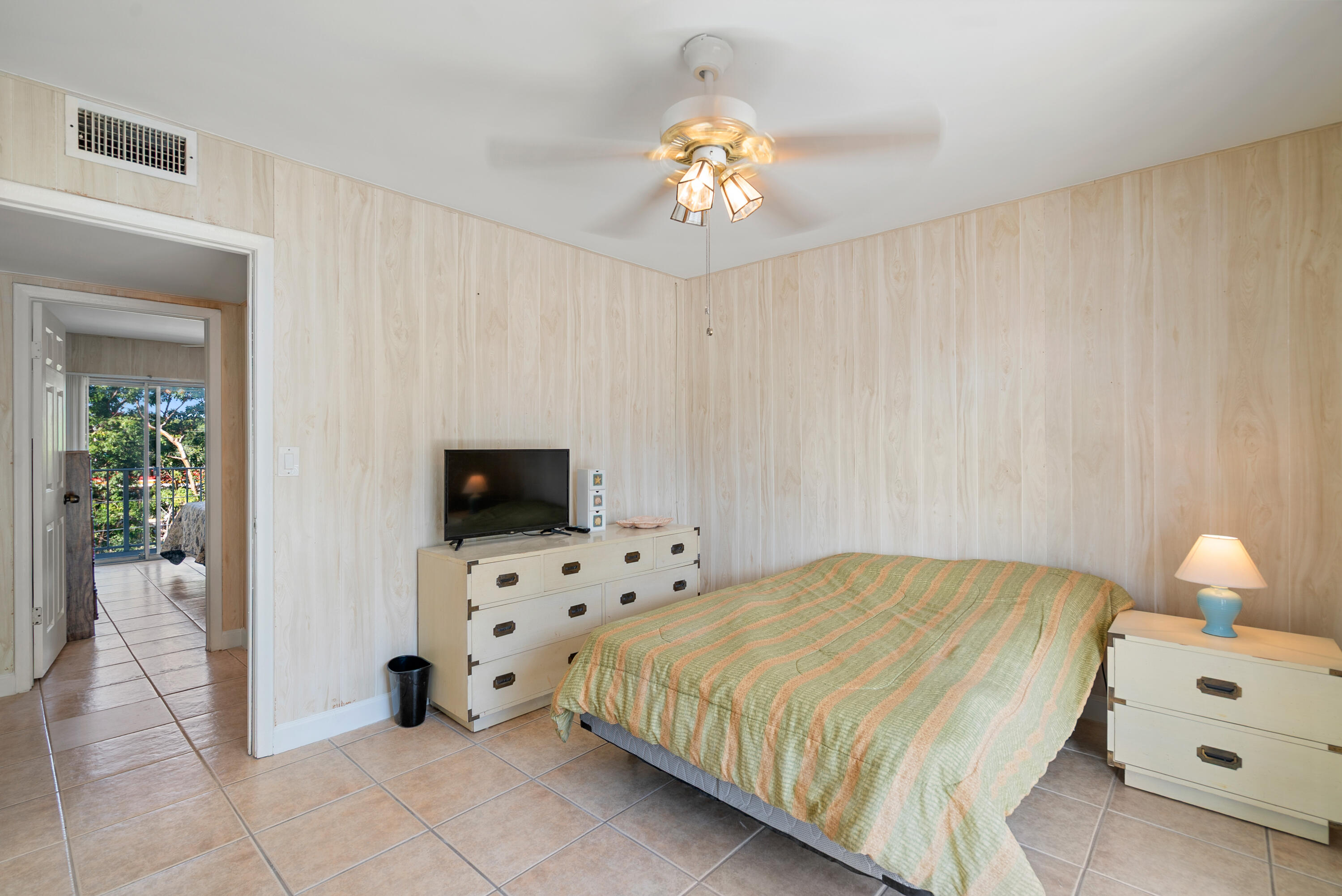 300 Ocean Drive, Unit 23 Key Largo, FL 33037 - Photo 20 of 29 a bedroom with a bed and a chandelier