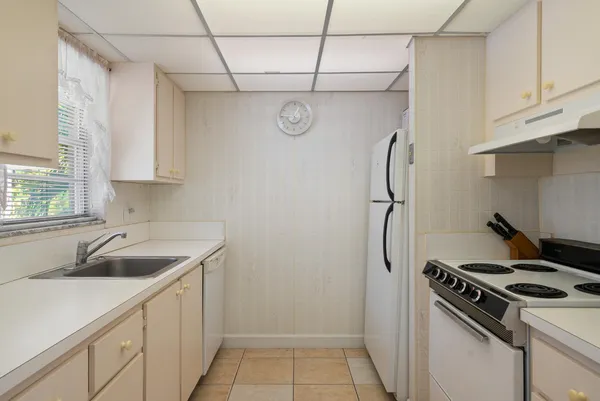 a kitchen with a sink cabinets and stainless steel appliances