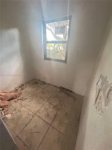 a view of a room that has a fan and window in it