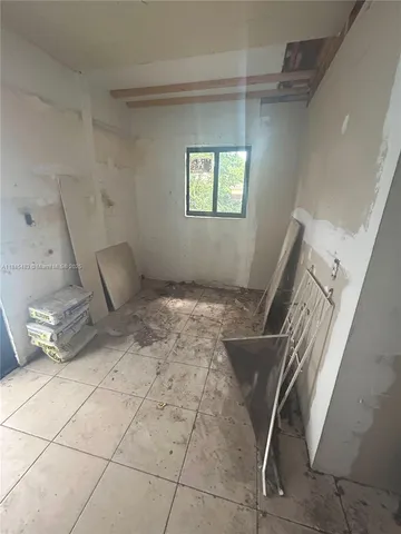 a view of a room with wooden floor and chair