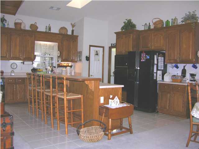 1423 Vinson Ray Road Baker, FL 32531 - Photo 4 of 16 a view of a dining room with furniture and a kitchen