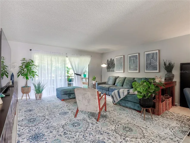 a bedroom with furniture and a flat screen tv