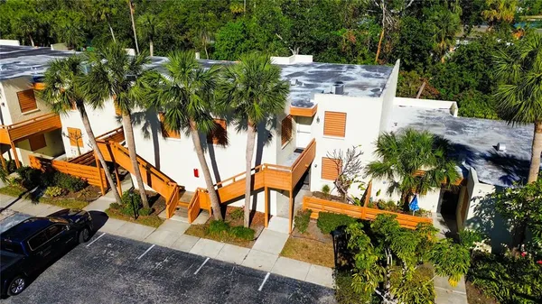 an aerial view of a house with a yard and trees