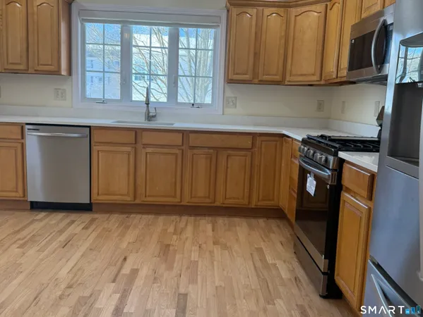 a kitchen with wooden floors and a sink