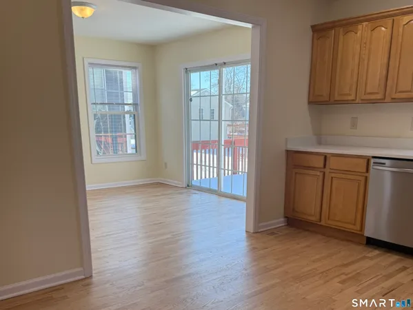 an empty room with wooden floor and cabinet