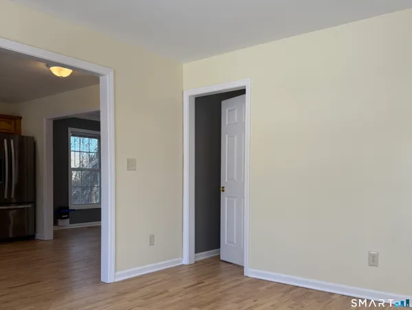 an empty room with wooden floor and closet