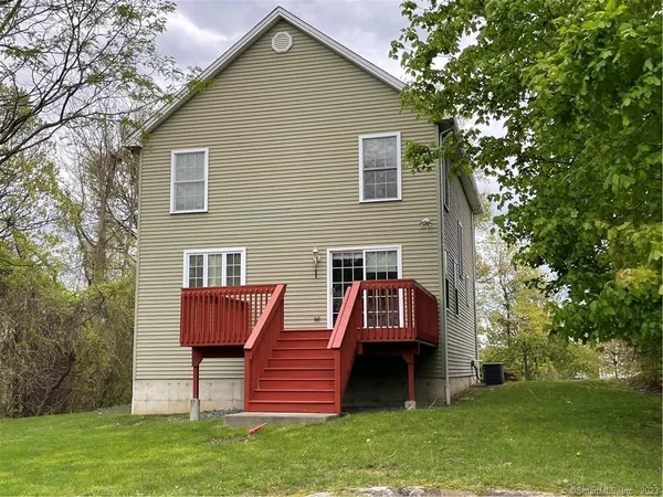 a view of a house with a yard and sitting area