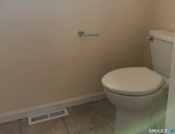 a white toilet sitting next to a white sink