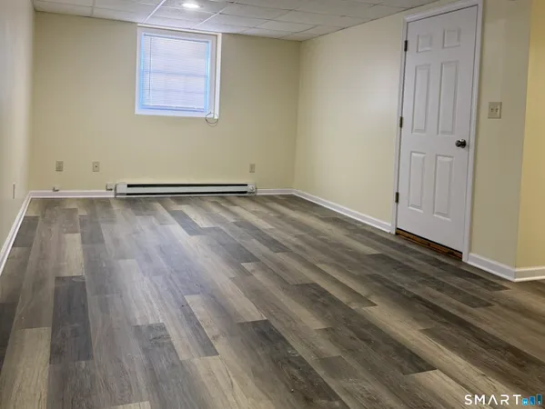 a view of a room with wooden floor