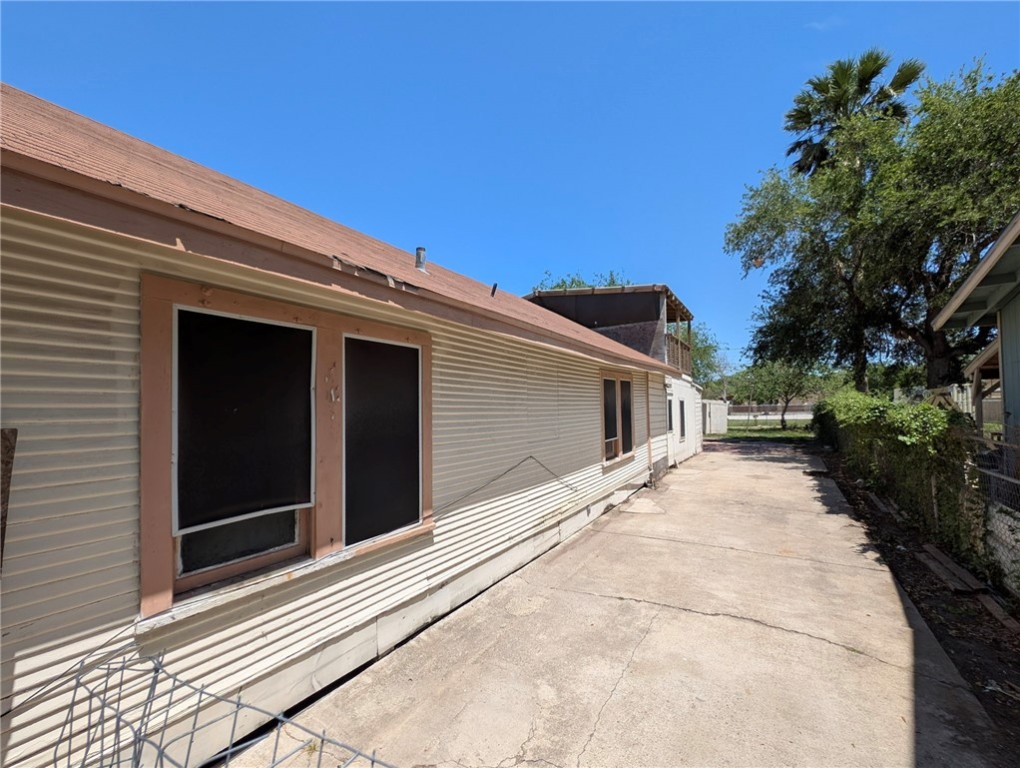 1114 11th Street Corpus Christi, TX 78404 - Photo 3 of 16 a yellow house with trees in front of it