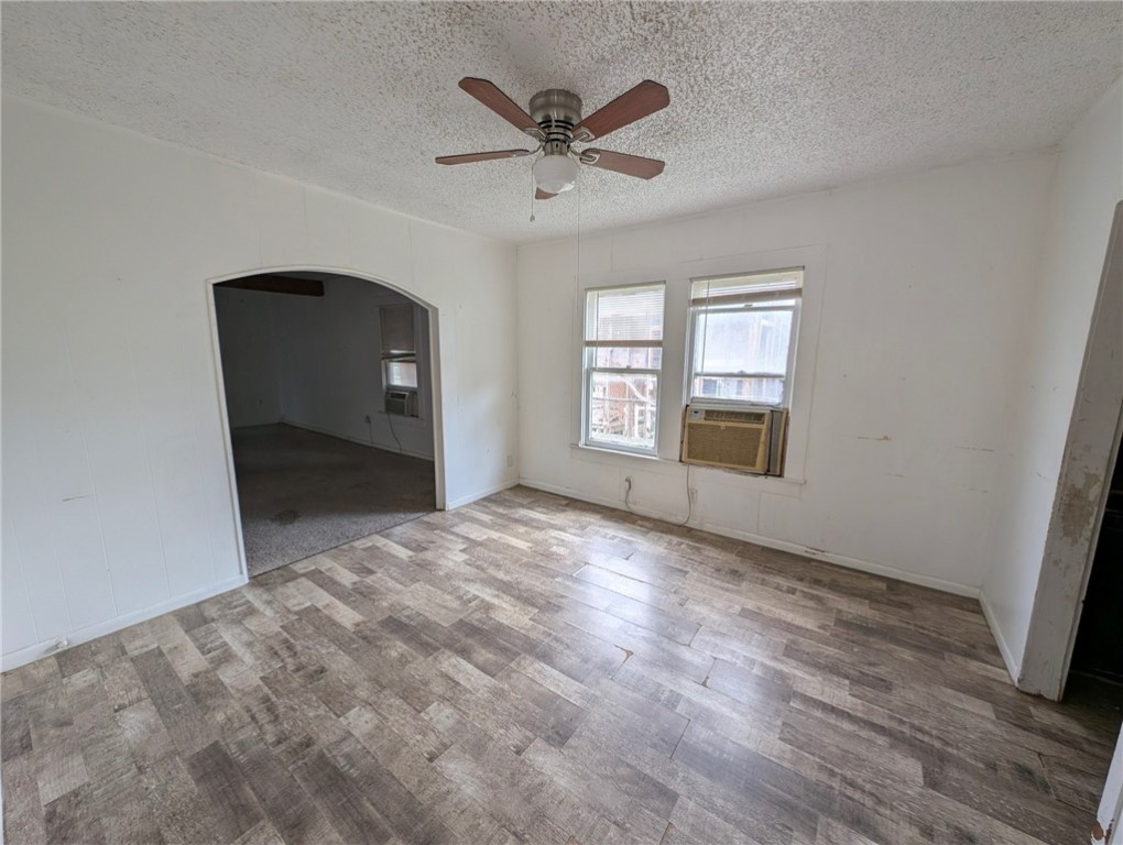 1114 11th Street Corpus Christi, TX 78404 - Photo 6 of 16 an empty room with windows and fan