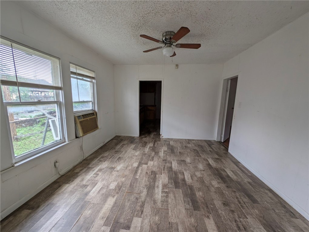 1114 11th Street Corpus Christi, TX 78404 - Photo 7 of 16 a view of empty room with wooden floor and fan