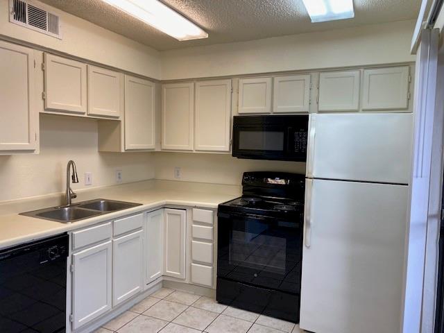 4748 Old Bent Tree Lane, Unit 803 Dallas, TX 75287 - Photo 10 of 20 a kitchen with a sink and white stainless steel appliances
